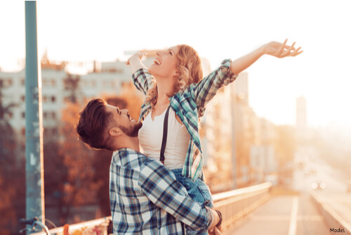 Man holding woman in the air