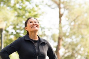 Woman outside in the sun smiling