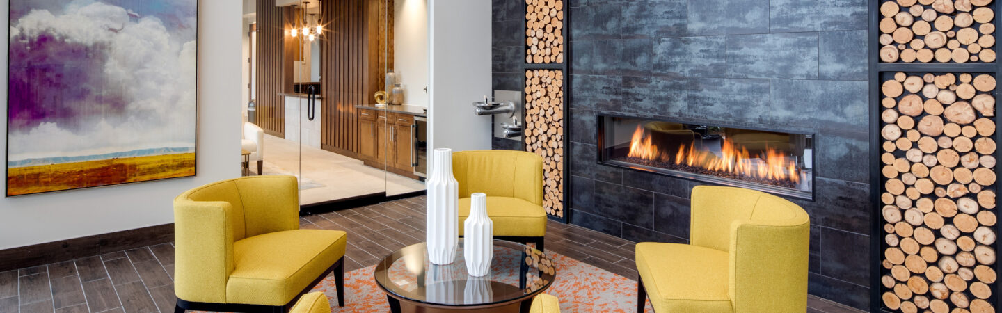 yellow seating chairs in front of gas fireplace