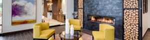 yellow seating chairs in front of gas fireplace