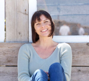 Happy middle aged woman smiling outdoors